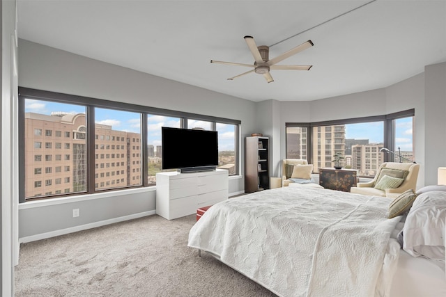carpeted bedroom with baseboards and ceiling fan