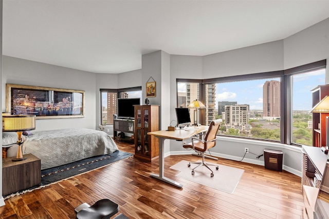 bedroom with baseboards and wood finished floors