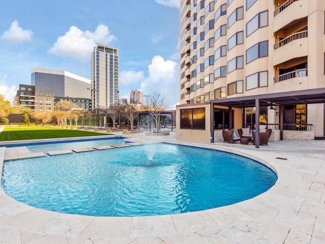 pool featuring a city view and a patio area