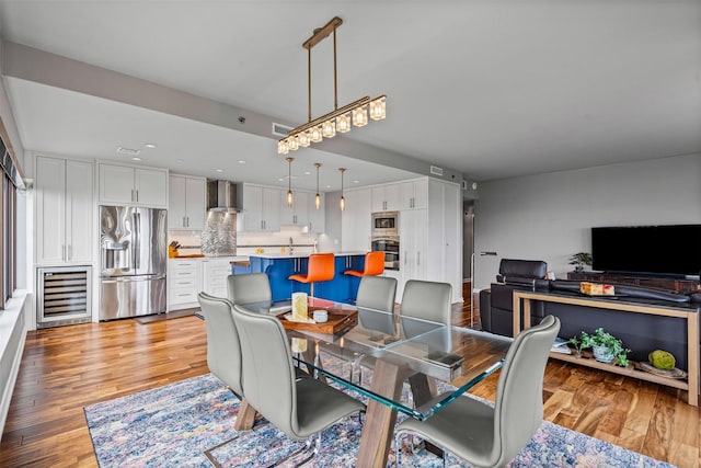 dining room featuring recessed lighting, light wood-type flooring, beverage cooler, and visible vents