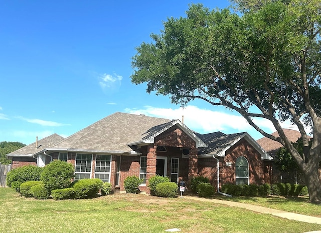 1561 Waterford Dr, Lewisville, TX 75077 - view of front of home featuring brick siding and a front yard