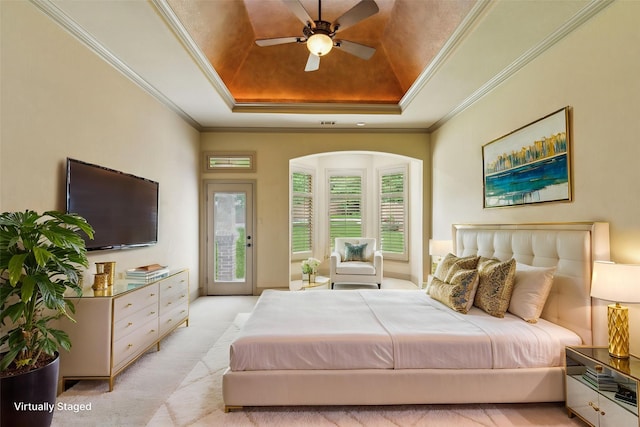 bedroom featuring crown molding, a raised ceiling, light carpet, and access to exterior