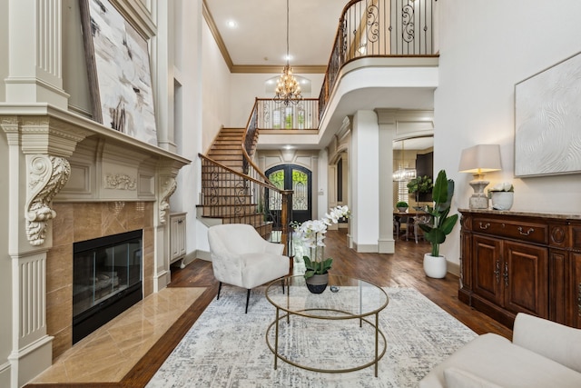 interior space featuring a high ceiling, an inviting chandelier, baseboards, and a fireplace