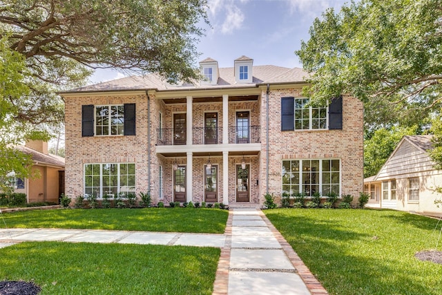 7538 Centenary Ave, Dallas, TX 75225 - view of front of property with a balcony, brick siding, and a front lawn