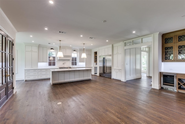 7538 Centenary Ave, Dallas, TX 75225 - kitchen featuring stainless steel built in refrigerator, beverage cooler, light countertops, healthy amount of natural light, and recessed lighting