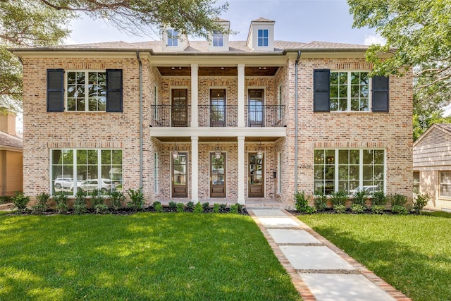 7538 Centenary Ave, Dallas, TX 75225 - view of front of home featuring a balcony, brick siding, a porch, and a front lawn