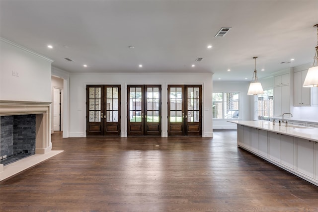 7538 Centenary Ave, Dallas, TX 75225 - unfurnished living room with a fireplace with flush hearth, french doors, dark wood finished floors, ornamental molding, and recessed lighting