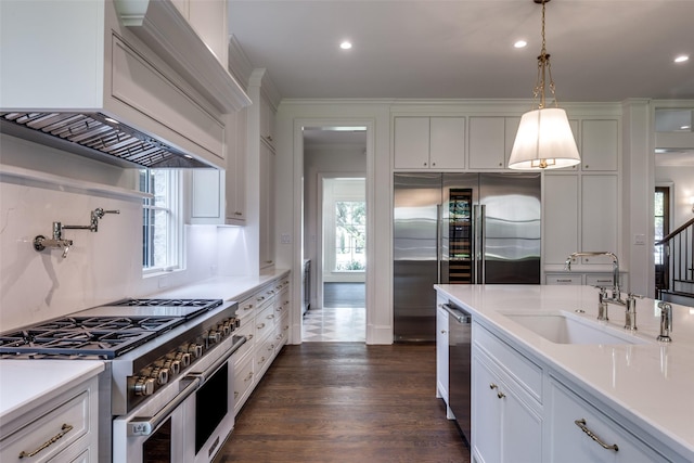7538 Centenary Ave, Dallas, TX 75225 - kitchen featuring premium appliances, a sink, white cabinetry, light countertops, and dark wood-style flooring
