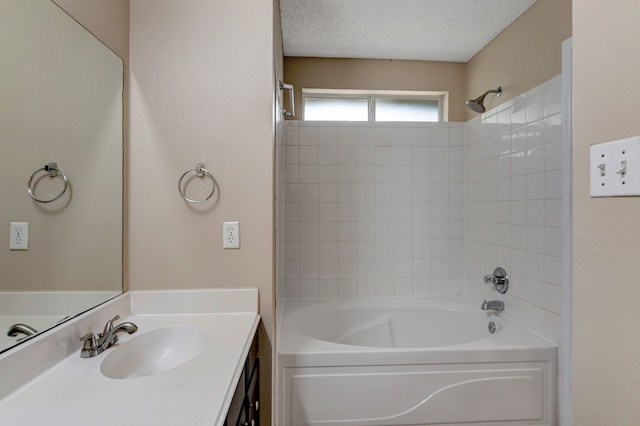 bathroom featuring vanity, a textured ceiling, and shower / washtub combination