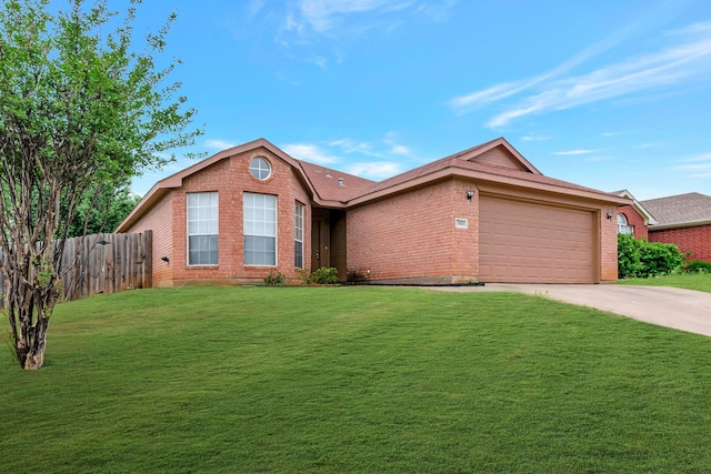 single story home featuring driveway, a front yard, a garage, brick siding, and fence