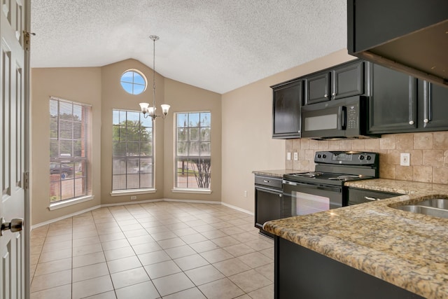 kitchen featuring decorative light fixtures, baseboards, decorative backsplash, lofted ceiling, and black appliances