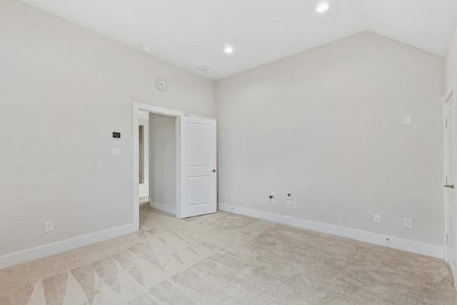empty room with recessed lighting, baseboards, light colored carpet, and visible vents