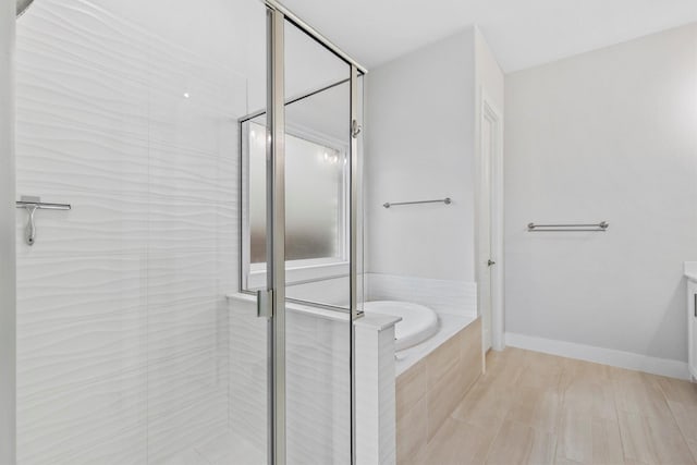 full bath featuring tile patterned flooring, a garden tub, and a stall shower