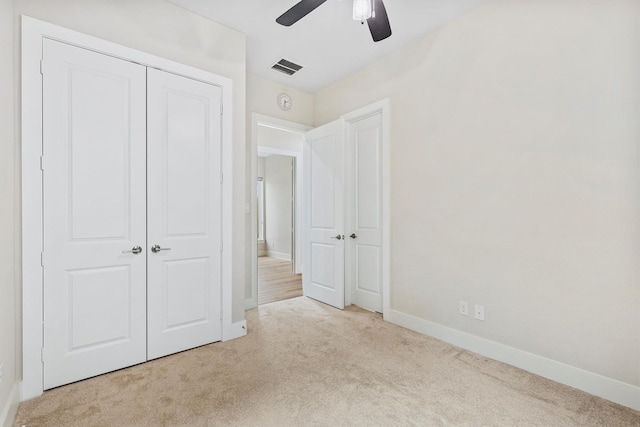 unfurnished bedroom featuring ceiling fan, carpet, baseboards, visible vents, and a closet