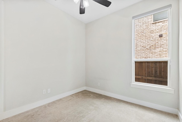 unfurnished room with carpet floors, baseboards, and a ceiling fan