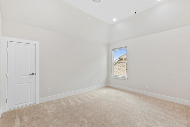 unfurnished room featuring baseboards and light carpet