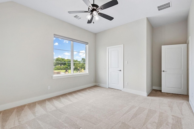 unfurnished bedroom with light colored carpet, baseboards, and visible vents