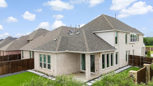 back of house with a fenced backyard, a shingled roof, a patio area, and brick siding