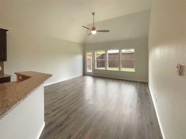 unfurnished living room with baseboards, a ceiling fan, dark wood-style flooring, and high vaulted ceiling