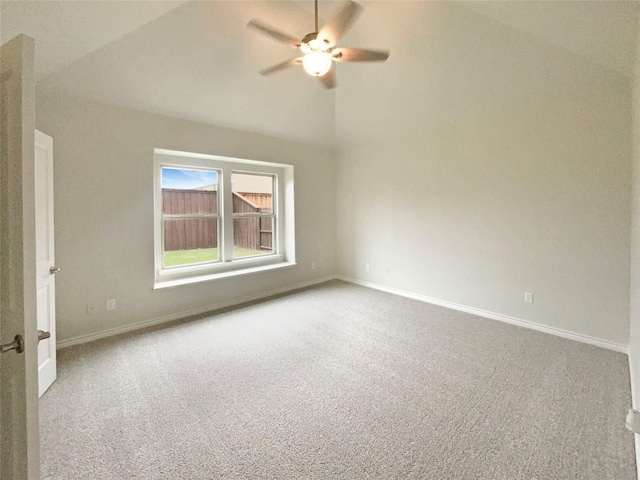 unfurnished room featuring baseboards, a ceiling fan, carpet, and vaulted ceiling