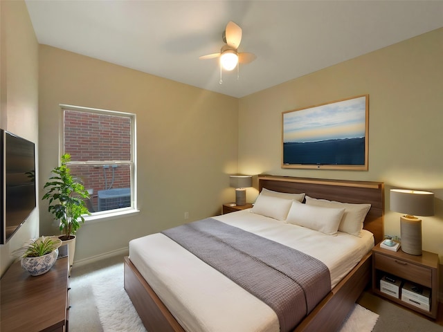carpeted bedroom featuring a ceiling fan and baseboards