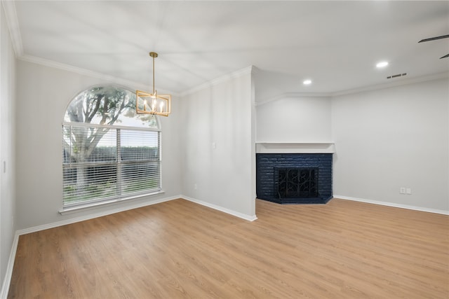 unfurnished living room featuring crown molding, baseboards, visible vents, and wood finished floors
