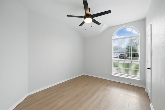 unfurnished room with baseboards, a ceiling fan, lofted ceiling, and wood finished floors