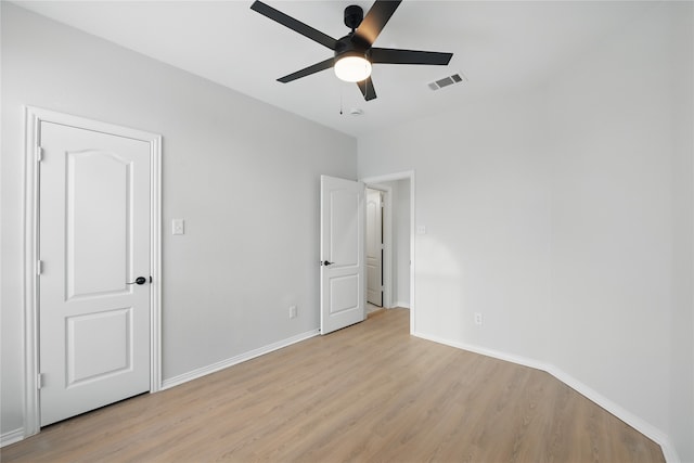 unfurnished bedroom with a ceiling fan, baseboards, visible vents, and light wood finished floors