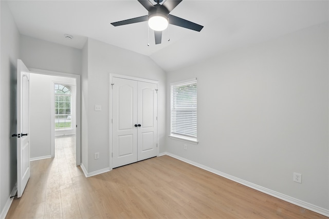 unfurnished bedroom with light wood-style floors, baseboards, and multiple windows
