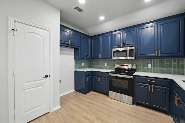 kitchen with blue cabinetry, appliances with stainless steel finishes, tasteful backsplash, light countertops, and light wood-style floors