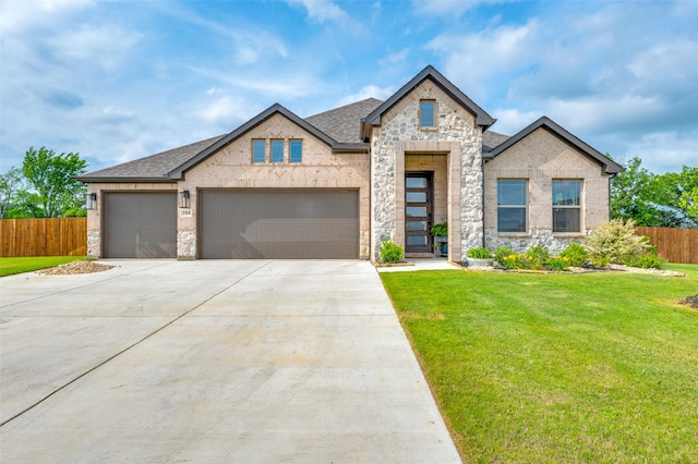 view of front facade featuring fence, concrete driveway, a front lawn, and stone siding