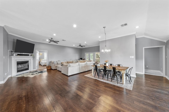 living area featuring crown molding, a high end fireplace, wood-type flooring, and visible vents