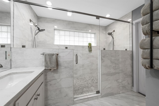full bath featuring vanity, a shower stall, recessed lighting, and marble finish floor