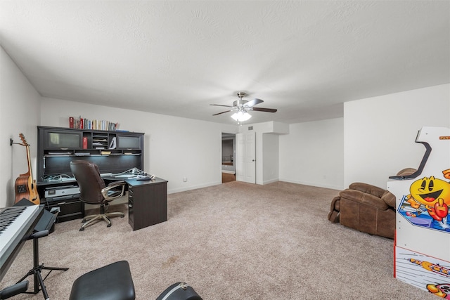 office space featuring carpet floors, baseboards, and ceiling fan