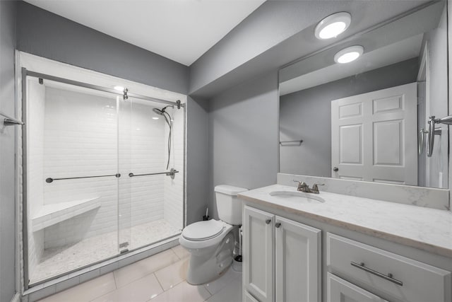 full bathroom with vanity, tile patterned floors, a shower stall, and toilet
