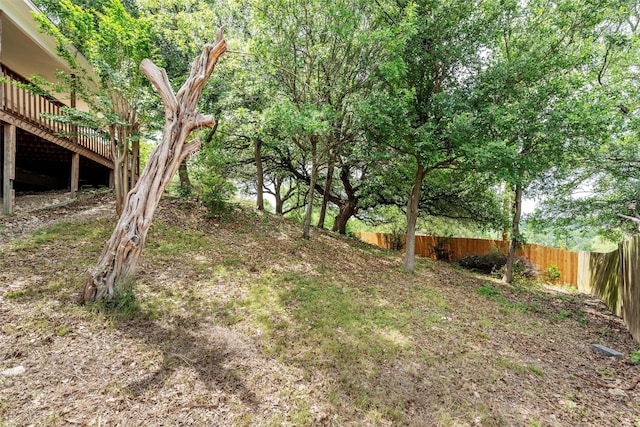 view of yard with fence and a wooden deck