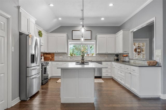 kitchen featuring white cabinets, stainless steel appliances, and lofted ceiling