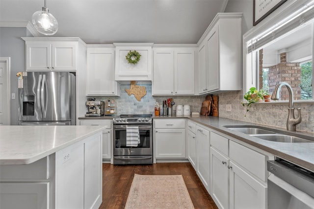 kitchen featuring decorative backsplash, stainless steel appliances, white cabinetry, and a sink