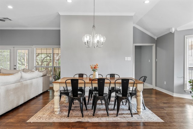 dining area with visible vents, plenty of natural light, wood finished floors, and a notable chandelier