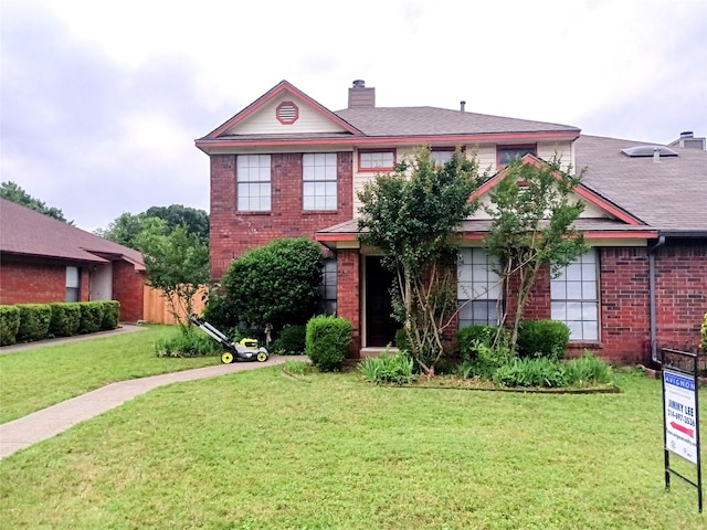 2109 Prairie Creek Trl, Garland, TX 75040 - view of front of house with a chimney, a front lawn, and brick siding
