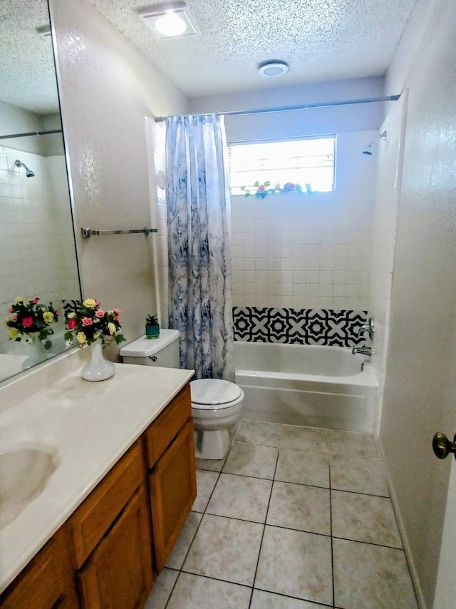 full bathroom featuring tile patterned flooring, vanity, toilet, shower / bathtub combination with curtain, and a textured ceiling
