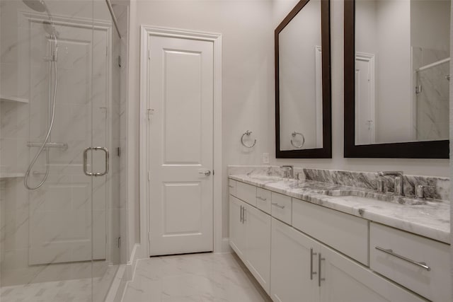 full bathroom with double vanity, a sink, a marble finish shower, and marble finish floor