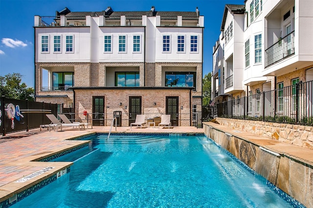 pool with fence and a patio area