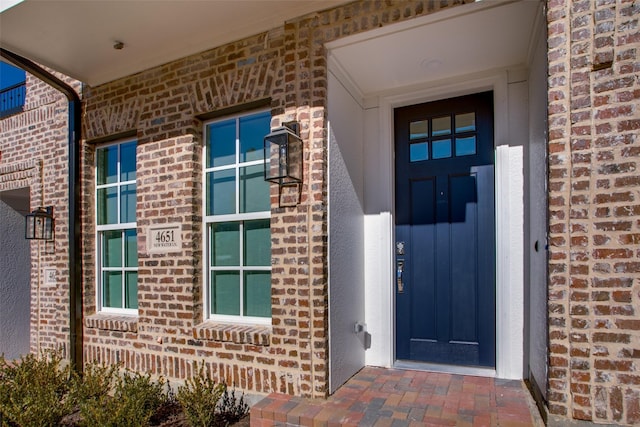 property entrance with brick siding