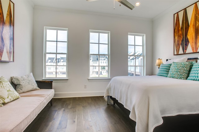 bedroom featuring crown molding, baseboards, multiple windows, and dark wood-type flooring