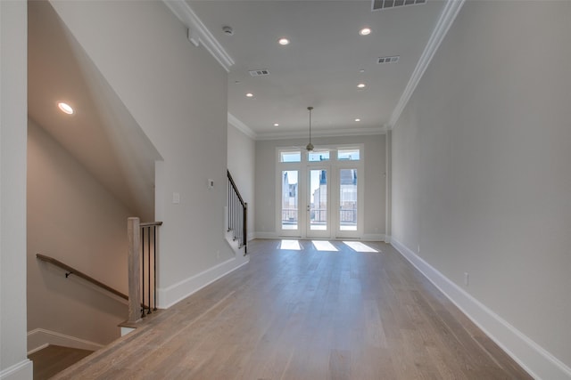 unfurnished living room featuring french doors, recessed lighting, baseboards, and wood finished floors