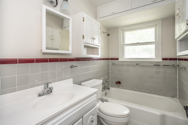 full bathroom with toilet, tile walls, wainscoting, and vanity