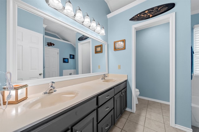 bathroom with a sink, lofted ceiling, tile patterned floors, and toilet