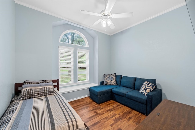 bedroom featuring crown molding, a ceiling fan, baseboards, and wood finished floors