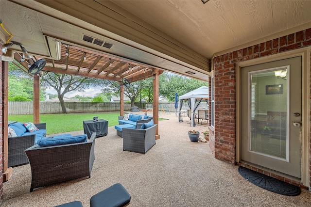 view of patio / terrace featuring a gazebo, a fenced backyard, outdoor lounge area, and visible vents